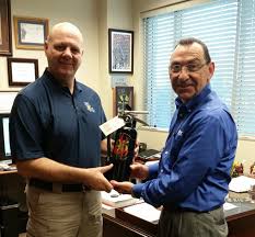 Danny Brown presenting fire ext to Butch Browning